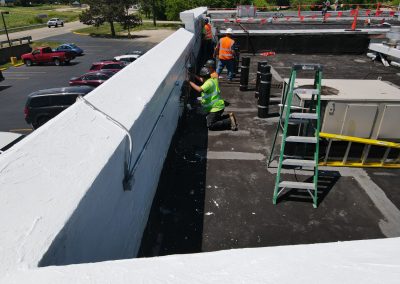 Contractors Work To Repair a Commercial Roof