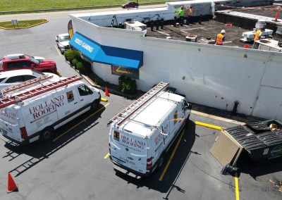 Holland Roofing vans on a repair job