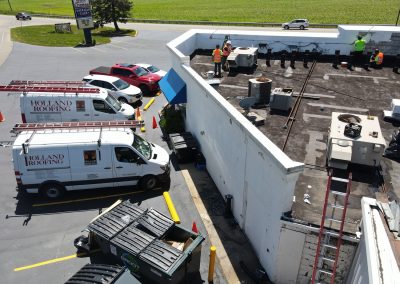 Roofing crew repairing commercial roof