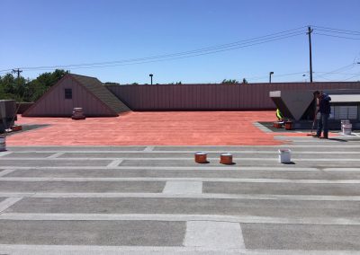 roof coating being applied