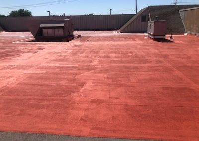 HVAC units on a red commercial roof