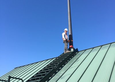 United States Flag waving from a roof peak